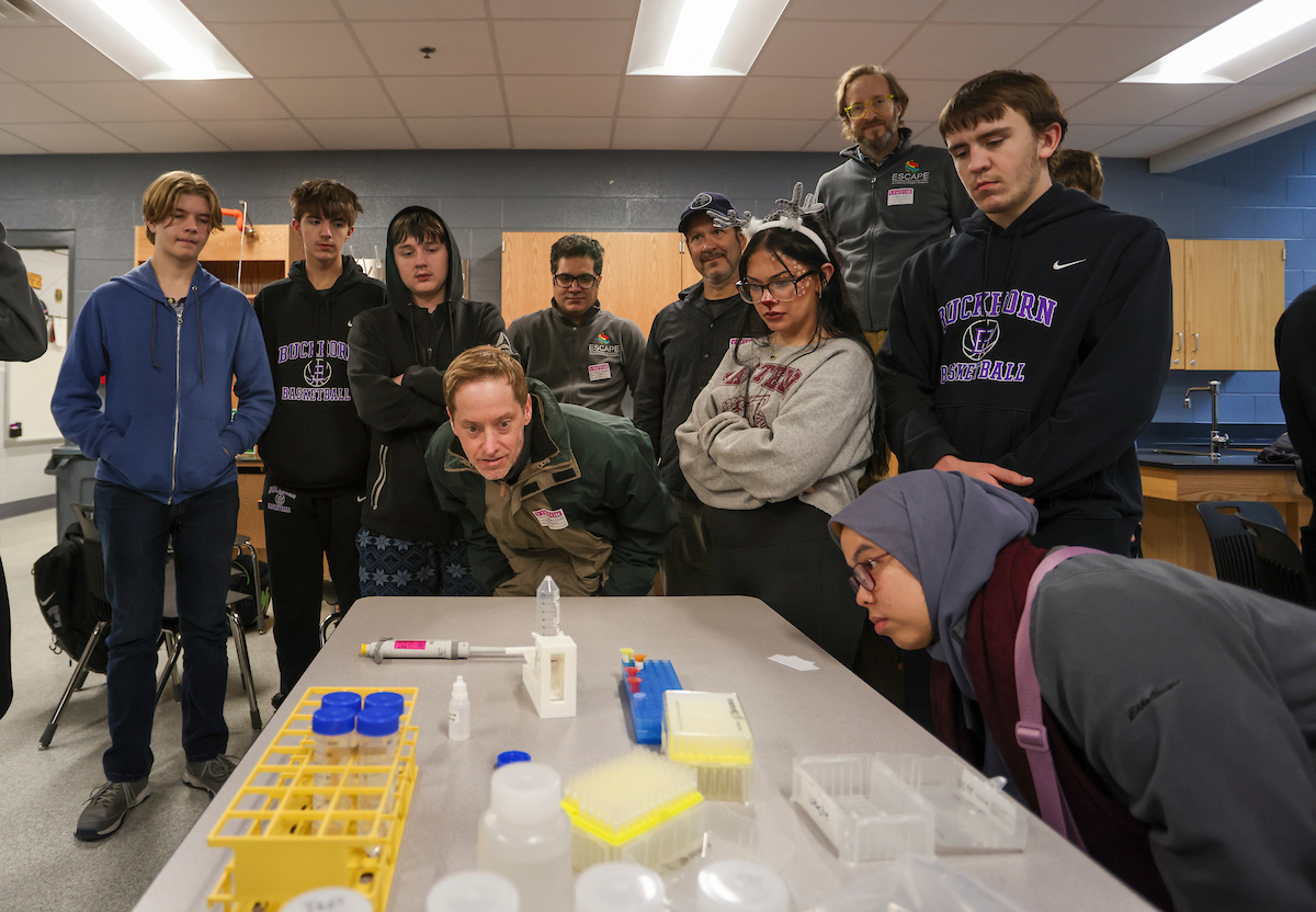 Buckhorn School students and ESCAPE researchers examine a water sample from Squabble Creek. Mark Cornelison | UK Photo